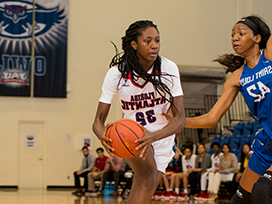 Two female basketball players playing basketball